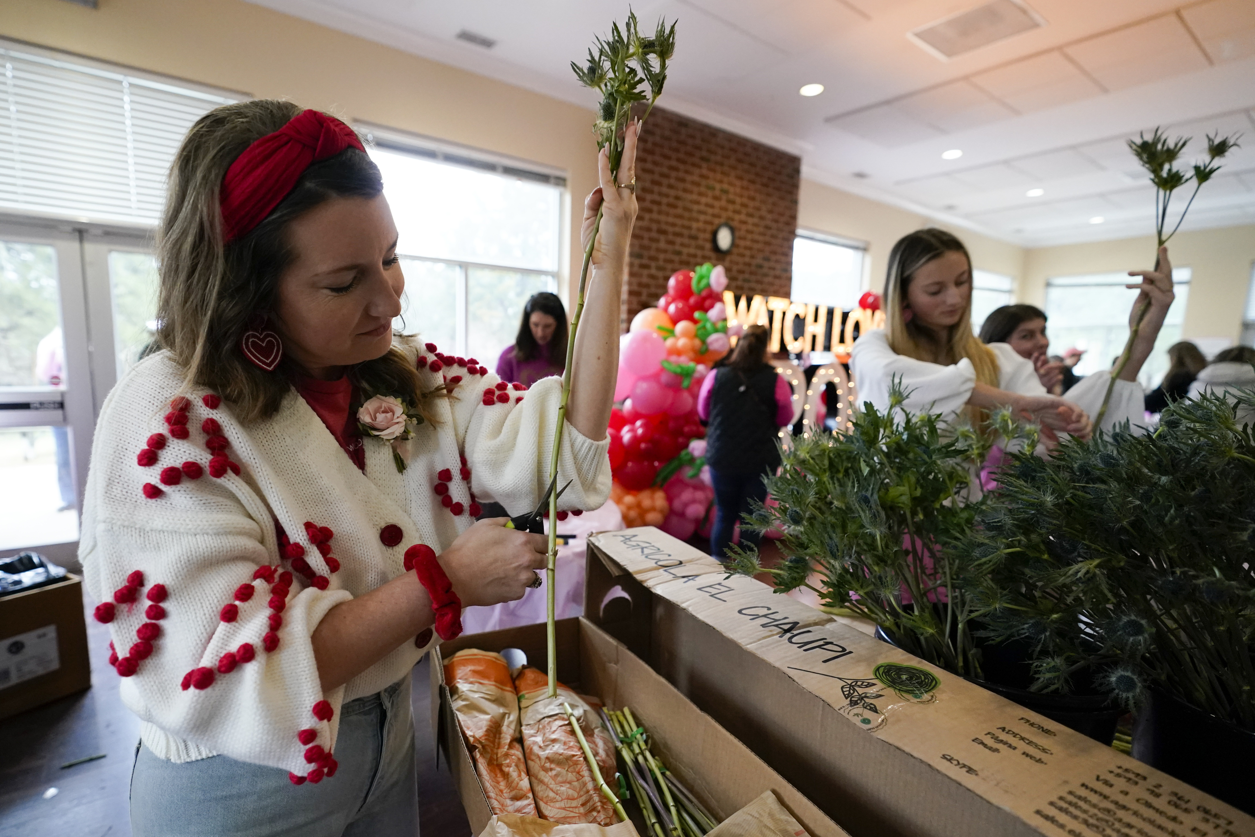 Volunteers deliver gifts to widows on Valentine’s Day. The project began in a florist’s driveway